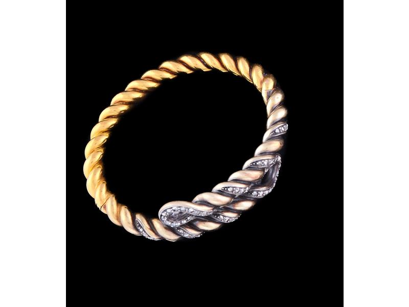 BRACELET rigide articulé en or jaune (750)...
