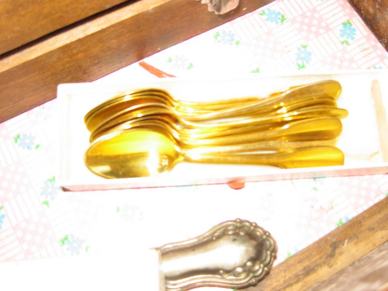 DOUZE PETITES CUILLERES en métal doré.
