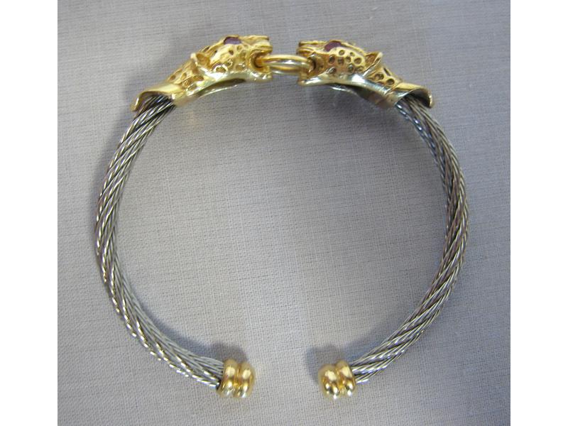 BRACELET rigide en or et acier à deux têtes...