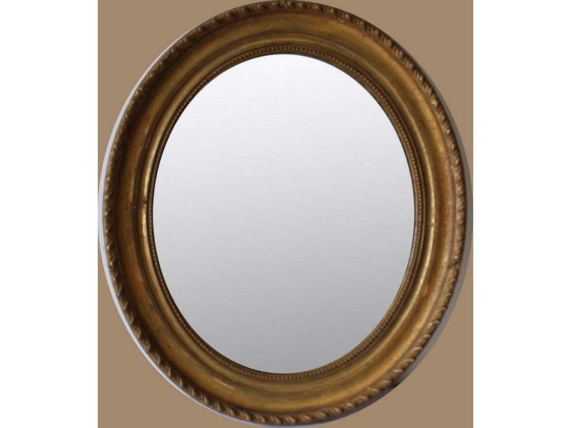 MIROIR ovale dans un cadre en bois doré à...