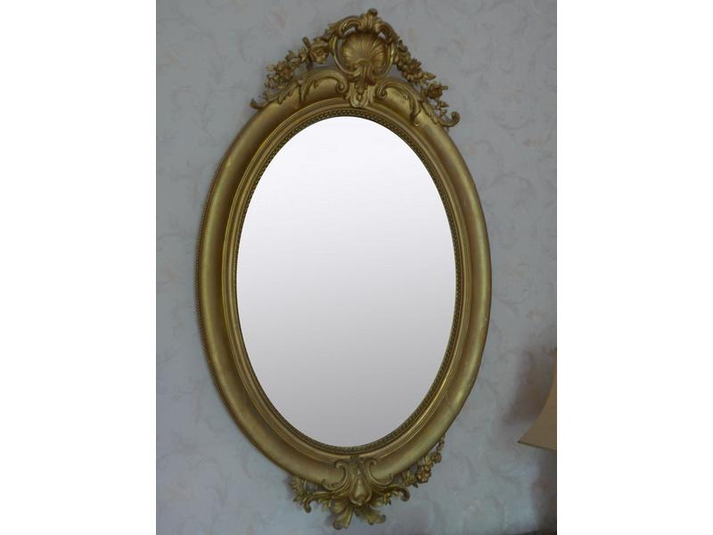 MIROIR ovale en bois et stuc doré à décor...