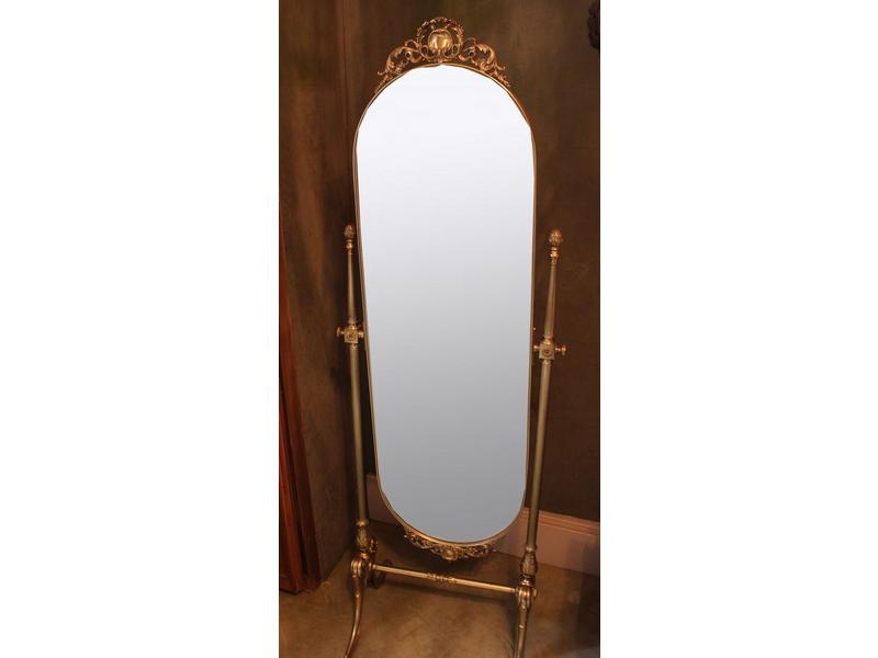 MIROIR PSYCHEE ovale en métal doré, à fronton...