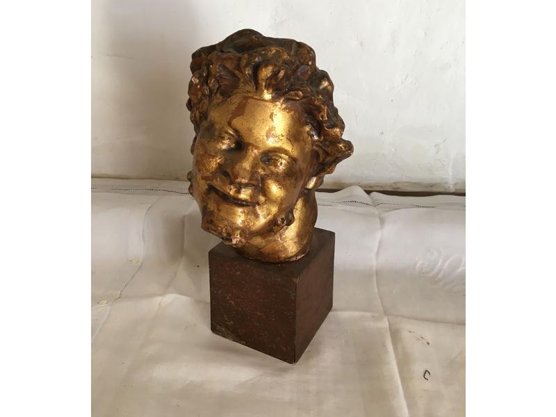 TÊTE DE SATYRE en terre cuite à patine dorée...