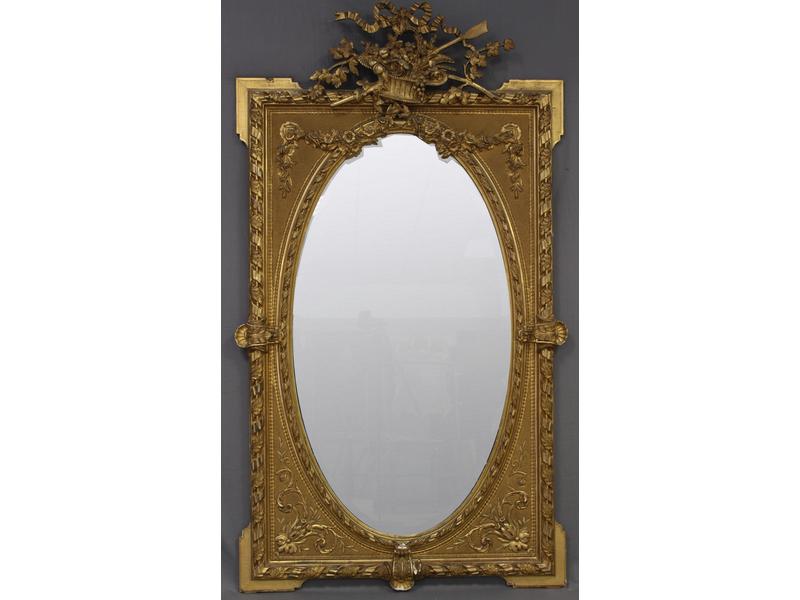 MIROIR DE CHEMINEE ovale biseauté, dans un...