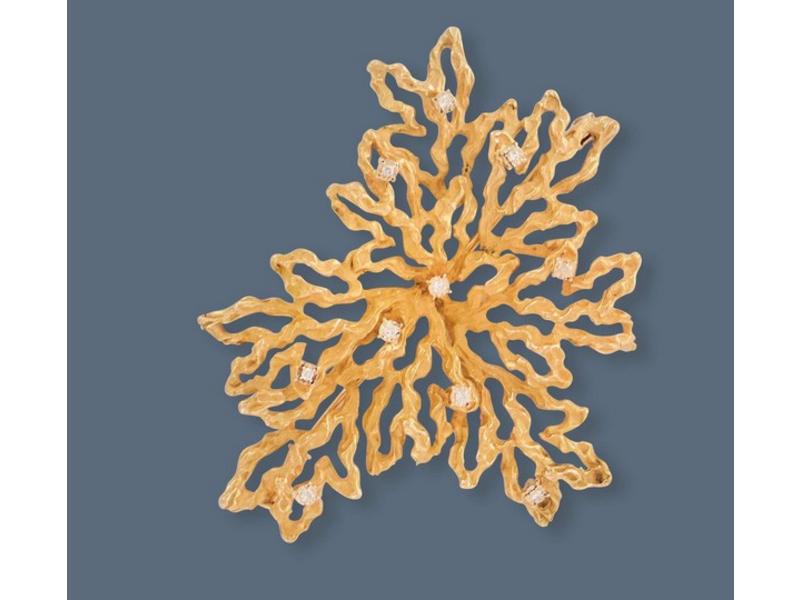BROCHE en or jaune (750) stylisant un corail...