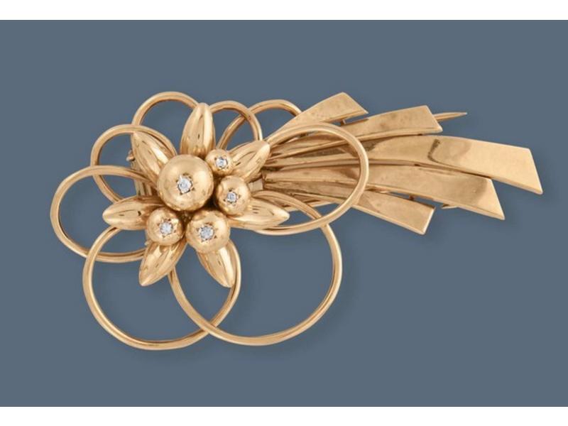 BROCHE en or jaune (750) stylisant une fleur...