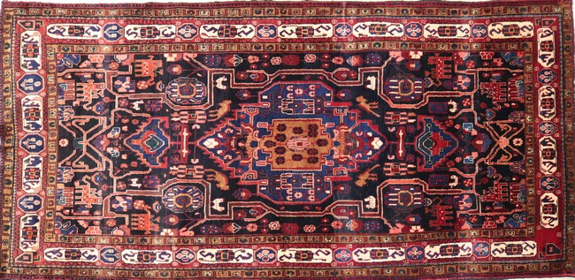 TAPIS en laine polychrome à décor en rouge...