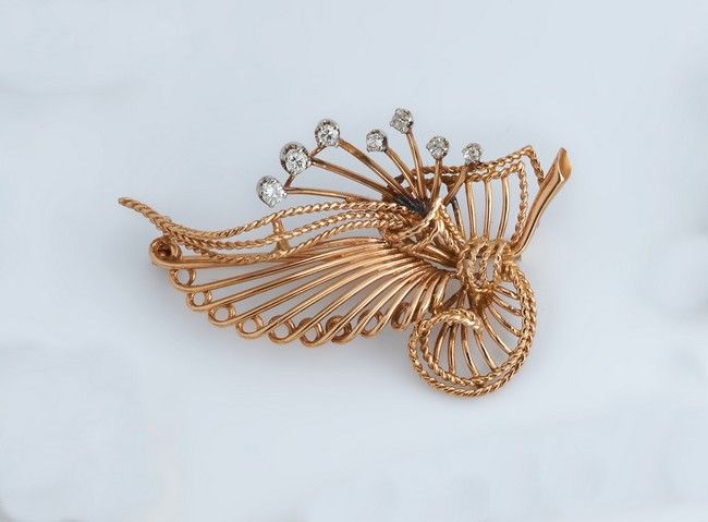 BROCHE STYLISÉE en or (750) sertie de sept...