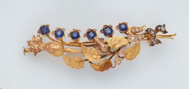 BROCHE en or (750) stylisant une branche...