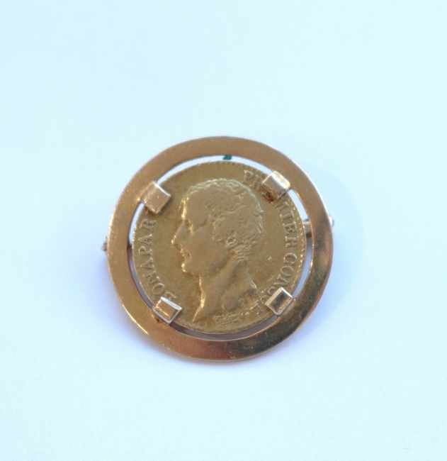 BROCHE ronde en or jaune (750) sertissant...