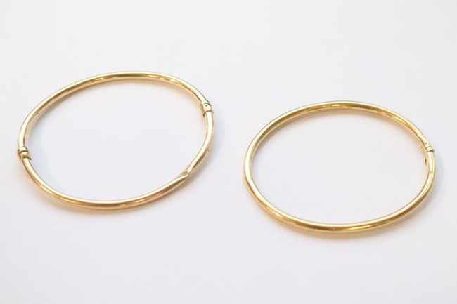 DEUX BRACELETS rigides articulés, l'un en...
