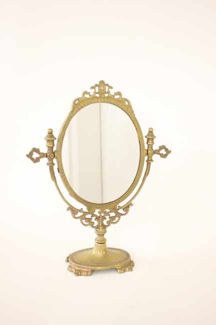 MIROIR DE TOILETTE ovale et pivotant à monture...