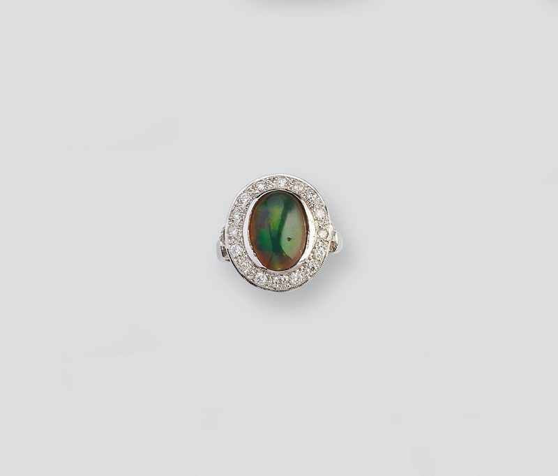 BAGUE en or gris (750) centrée d'une opale...