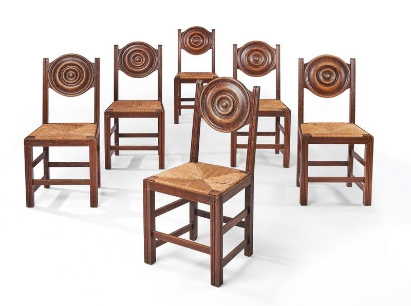 SIX CHAISES en chêne teinté, mouluré à dossier...