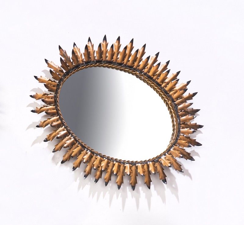 MIROIR SOLEIL ovale dans un cadre en métal...