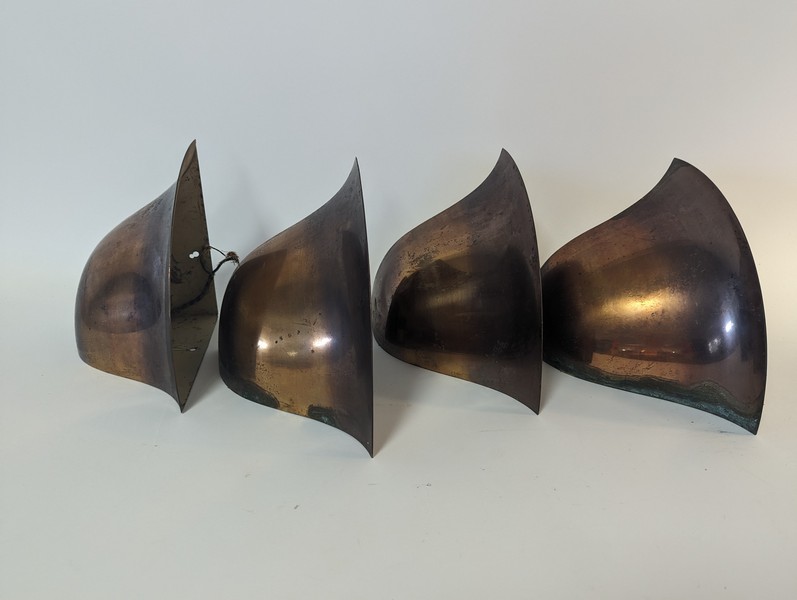 SUITE DE QUATRE APPLIQUES d'angles en cuivre,...