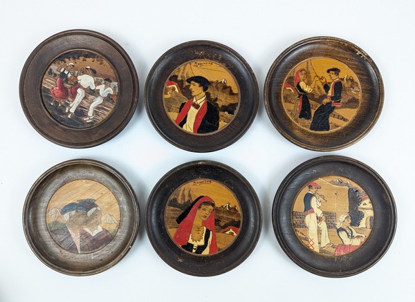 SIX ASSIETTES ou MÉDAILLONS en bois pyrogravé...