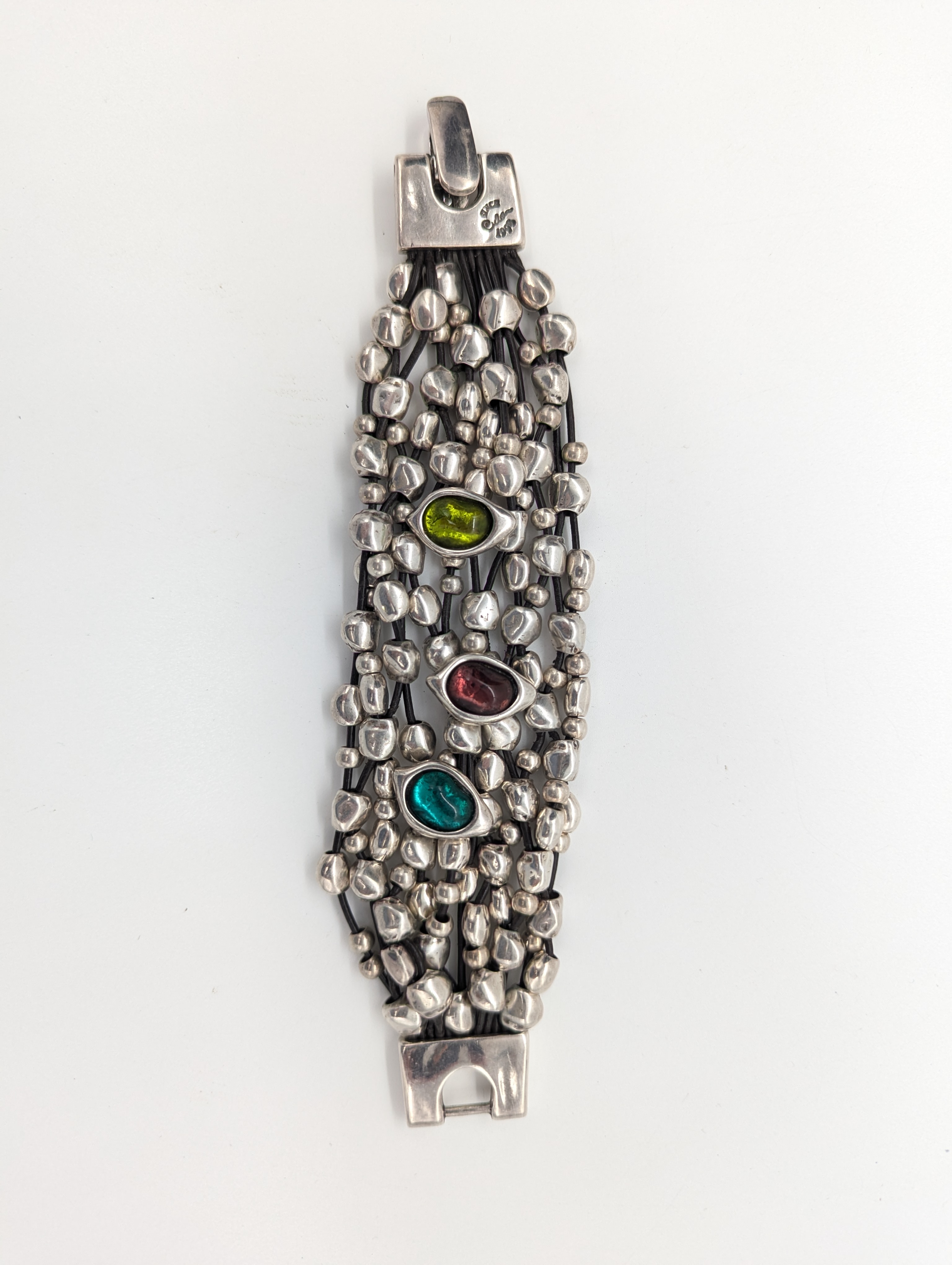 BRACELET en métal argenté à rangs en cuir...