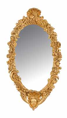 MIROIR ovale dans un cadre en bois sculpté...