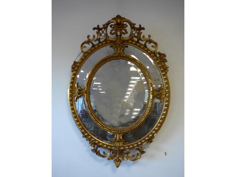 MIROIR ovale dans un cadre en bois stuqué...