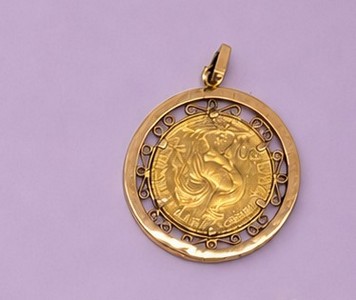 PENDENTIF en or (750) serti d'une pièce 20F...